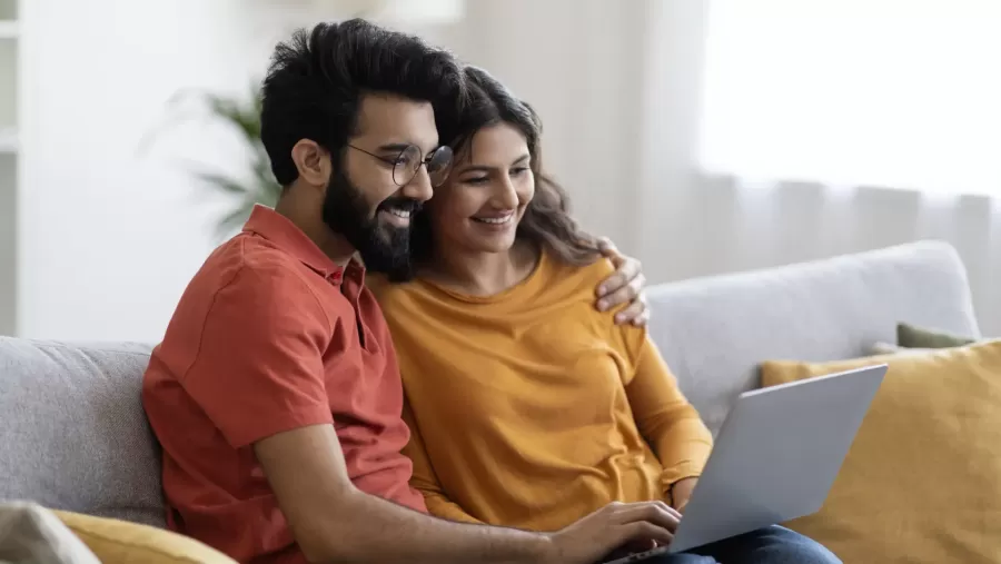 Couple on laptop for car loan process to apply online for car finance