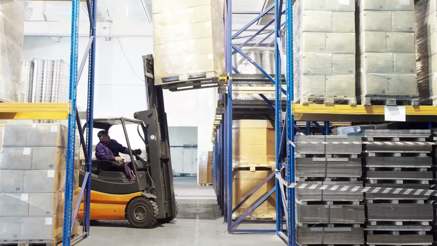 Forklift on finance lease lifting a pallet of goods in warehouse